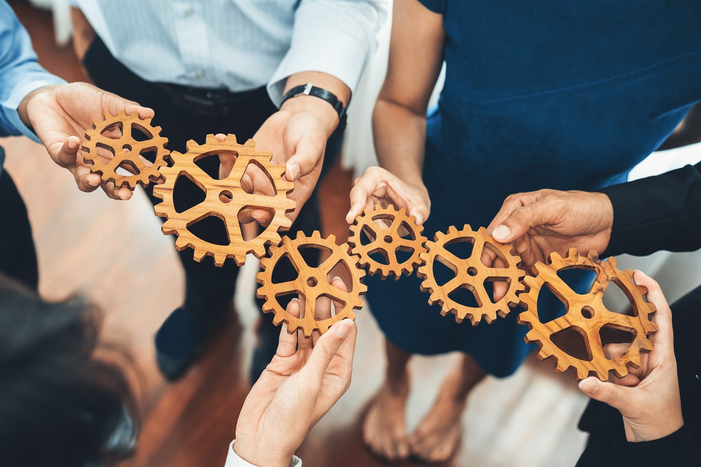 Hands fitting gears together: tools that mesh with the way your teams work