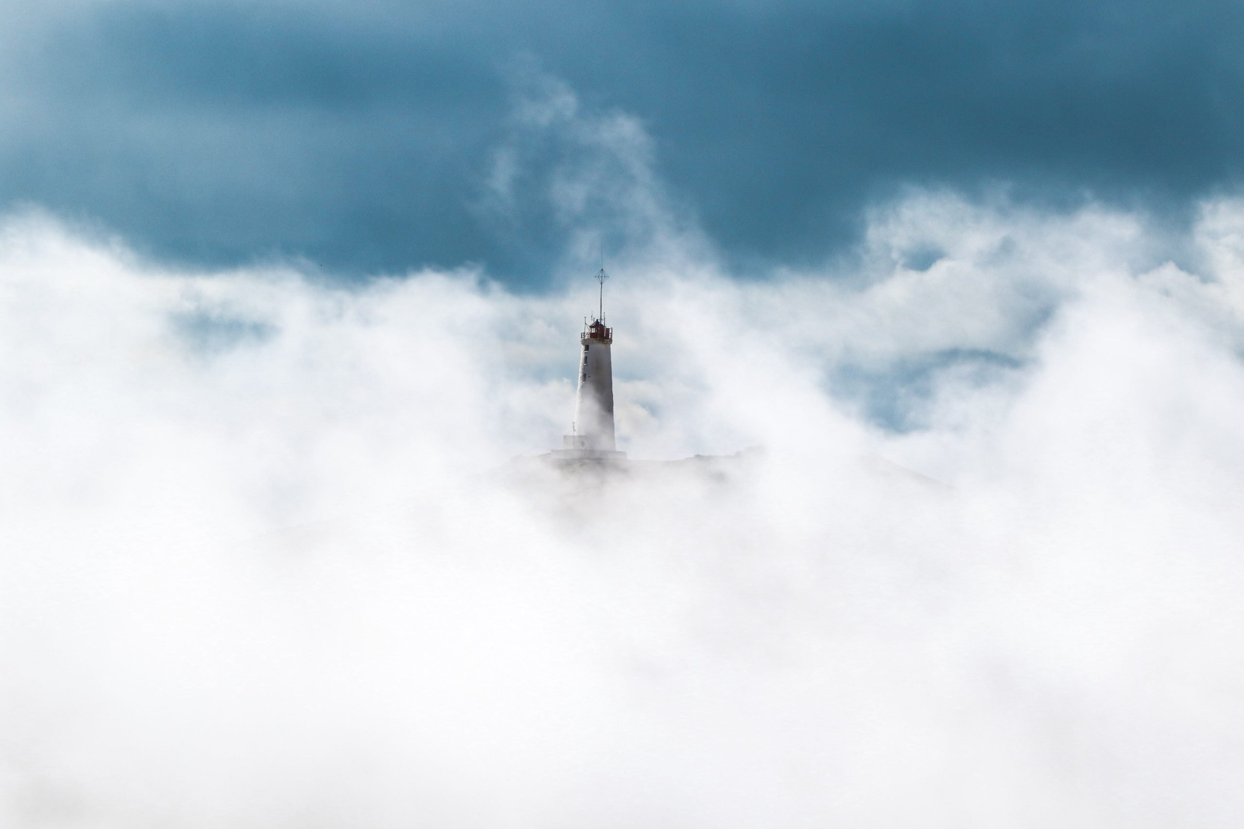 pexels-jeremy-bishop-2524873 lighthouse showing inthe clouds